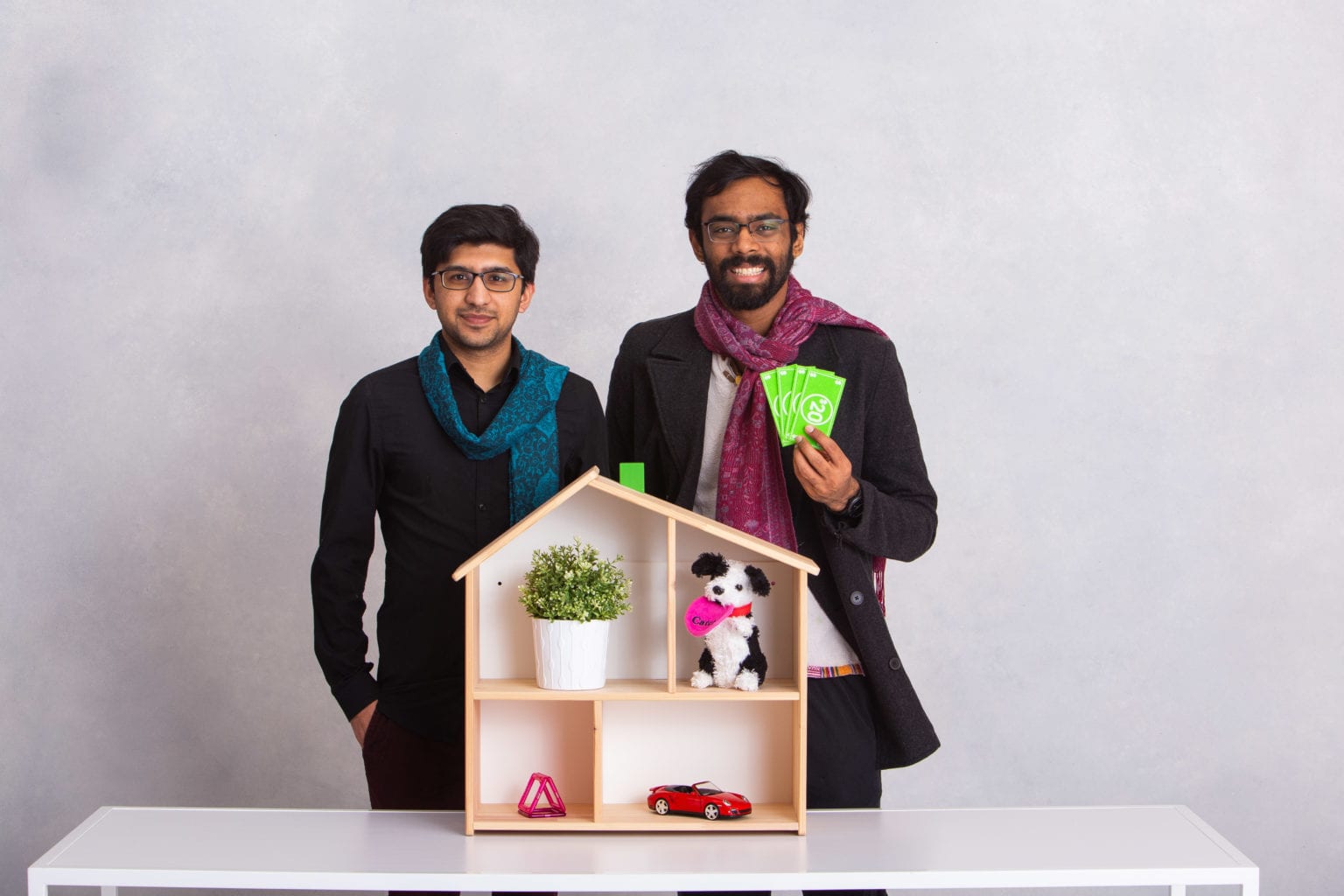 Rashid and Abhiroop standing in front of a model house